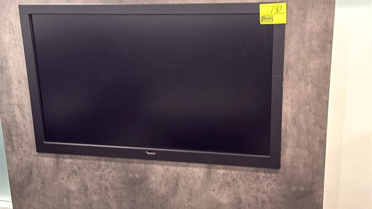 Samsung 50" flat screen color display monitor. Features a black bezel casing. Wall-mounted design. Wall panel in background not included.