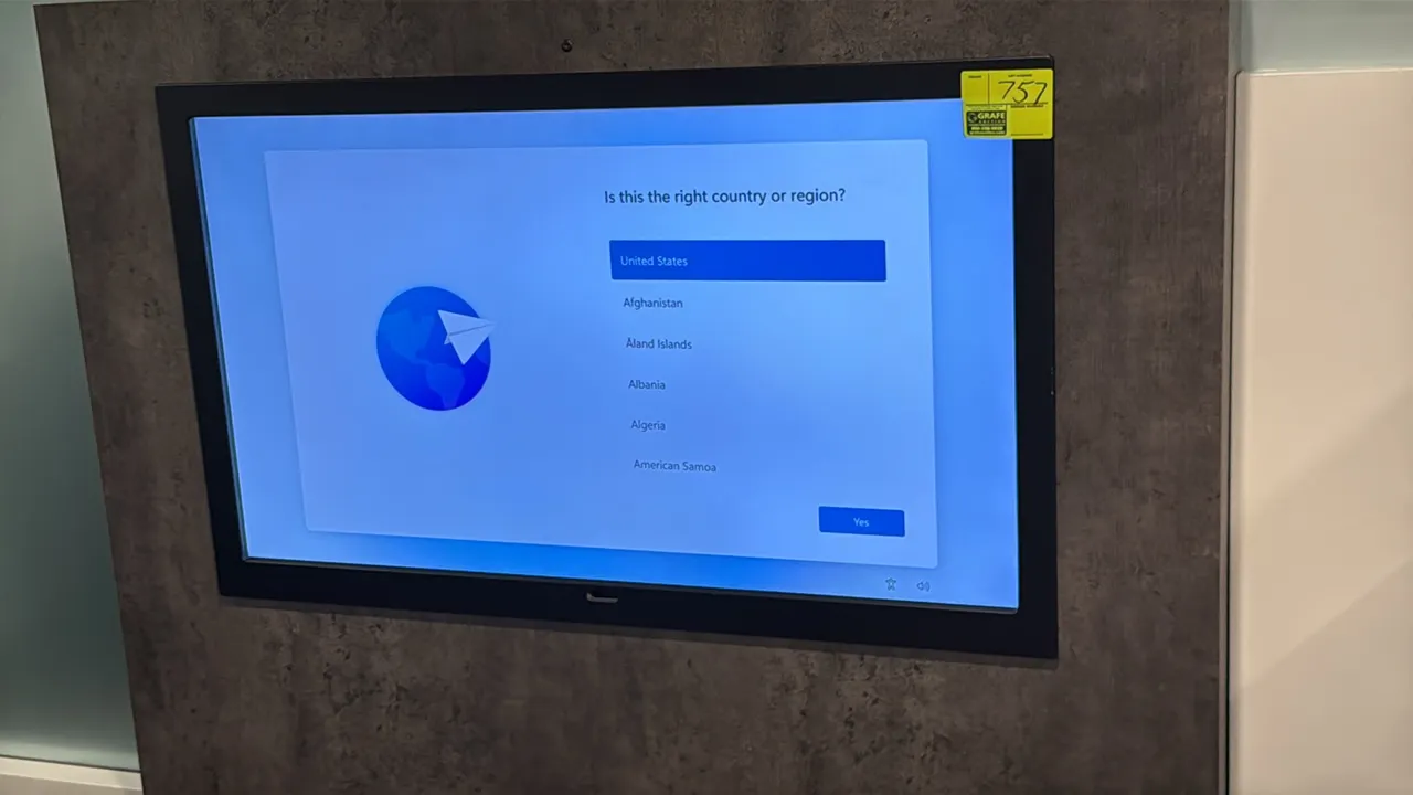 Samsung 50" flat screen color display monitor. Features a black bezel. Wall-mounted. Surround enclosure and background not included.