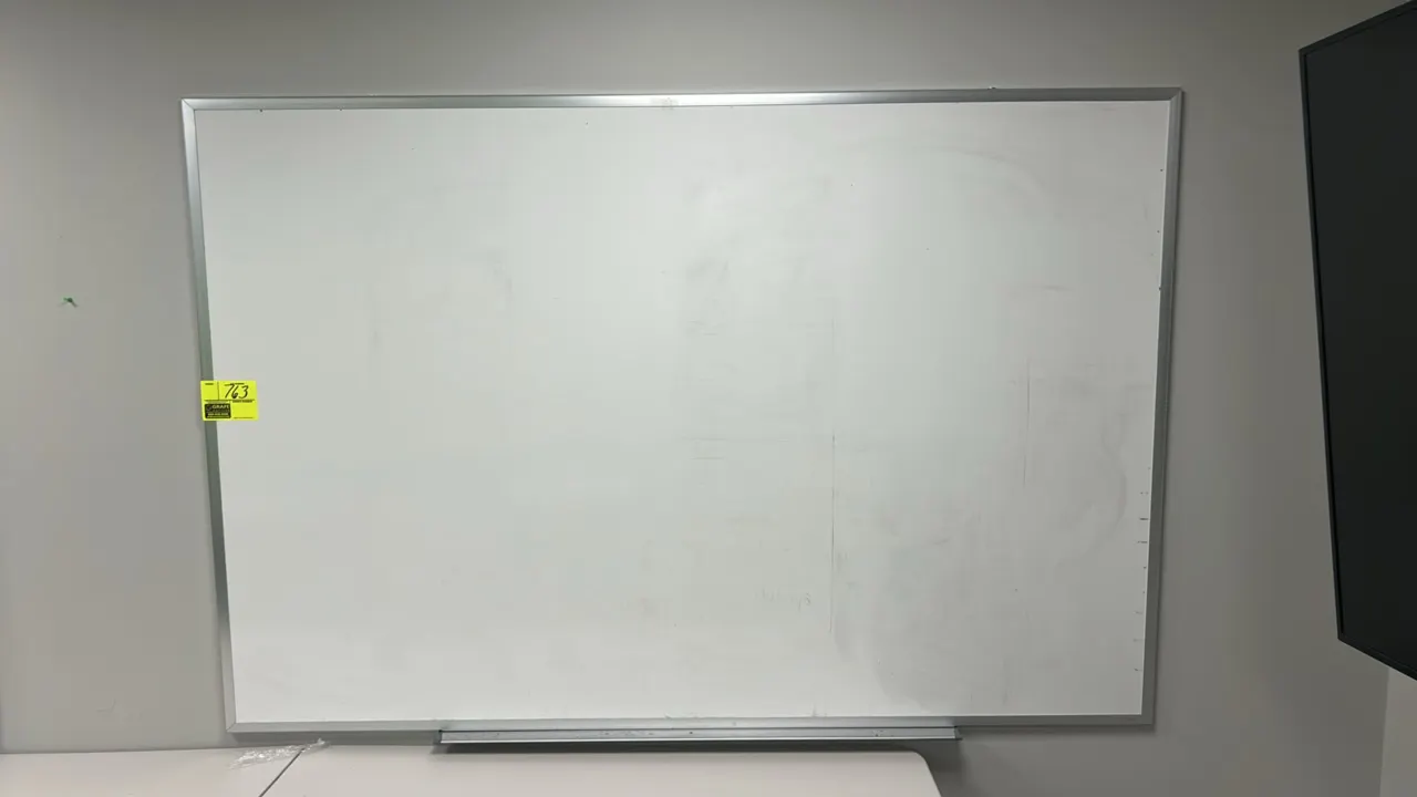 Stainless steel framed whiteboard. Features an integrated bottom marker tray. 6' x 4'. Wall-mounted design. Table not included.