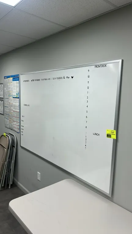 Stainless steel framed whiteboard. Features a dry-erase writing surface and wall-mount design. Dimensions: 6' x 4'. Surrounding items not included.