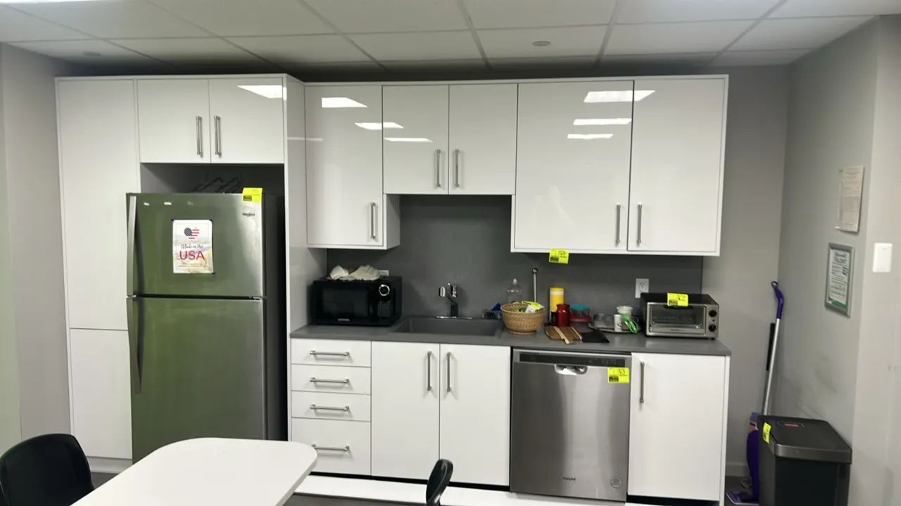 Infinity Plus laminate cabinets with laminate countertop and Blanco sink. Features white gloss cabinet doors, grey laminate countertop with backsplash