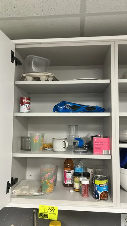 Assorted break room and kitchen supplies. Includes bowls, drinkware, mugs, food storage containers, cutting board, utensils, dry goods, cleaning chemi