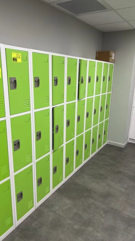 AdirOffice 3-compartment metal lockers. Features green louvered doors, white steel frames, recessed latch handles with lock slots, card label holders,