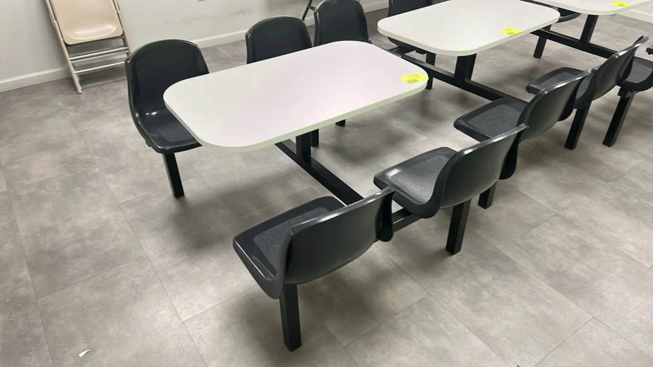 Laminate 4-person break room table. Features a white laminate tabletop with rounded corners and (4) attached black molded plastic seats. 41" x 24". Mo