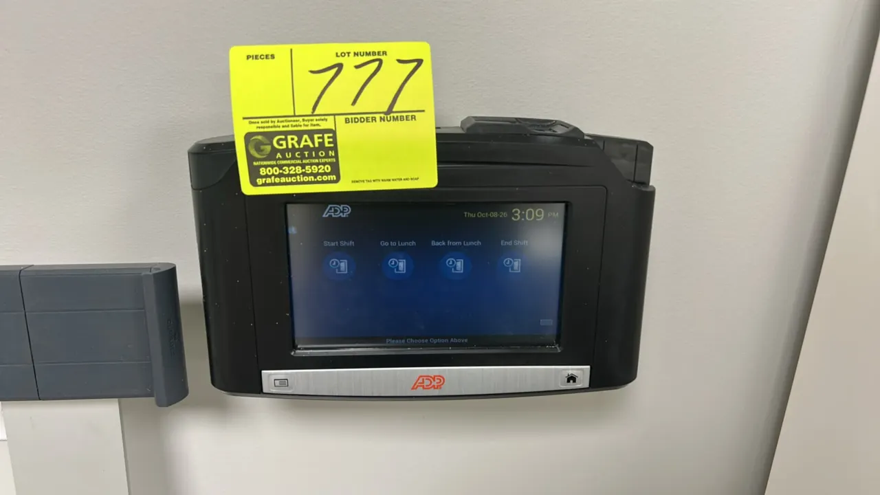 ADP InTouch electronic time clock and attendance terminal. Features color touchscreen display and integrated top reader module. Wall mounted.