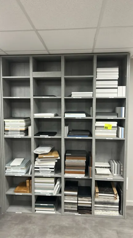 Assorted laminate cabinet and countertop samples. Features a variety of door profiles, colors, and finishes including Shaker style, woodgrain, solid c