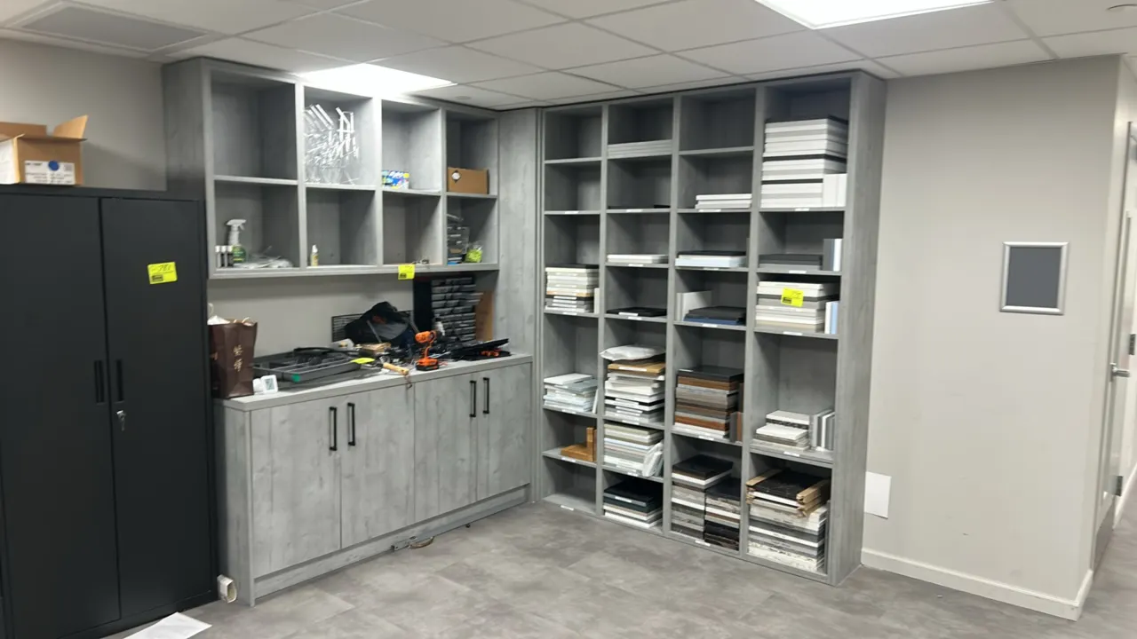 Infinity Plus laminate cabinets with laminate countertop. Features gray woodgrain laminate construction, a 4-door lower cabinet, upper open cubby stor