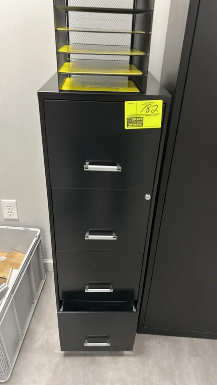 Metal 4-drawer vertical filing cabinet. Features a black finish, silver-tone pull handles, and integrated lock cylinder. Organizer on top and contents
