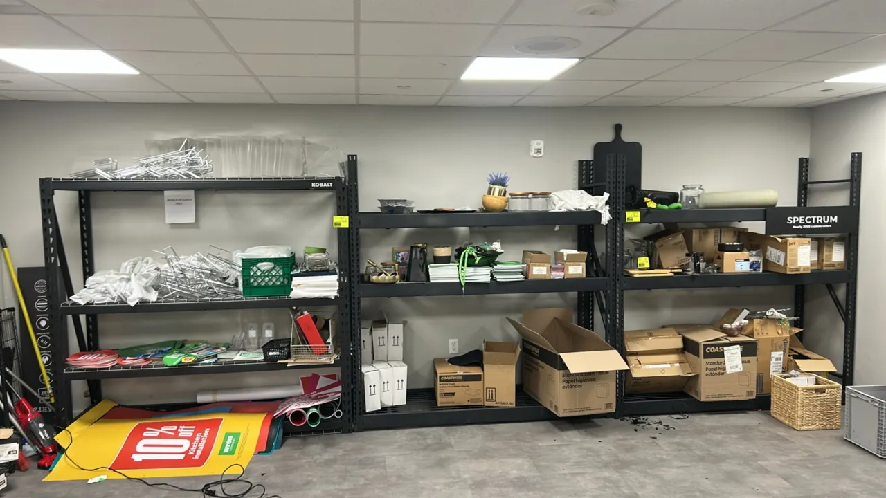 Assorted lot of retail and showroom contents from (3) shelving racks. Includes metal bag and display stands, solid surface countertop samples, assorte