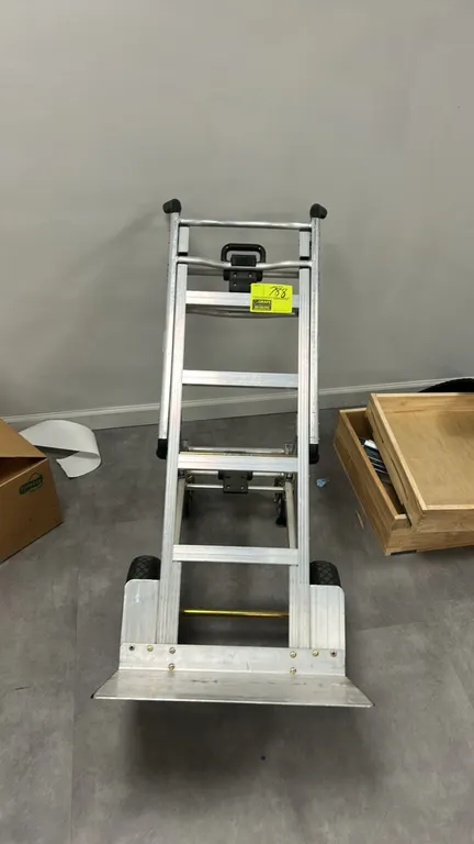 Cosco 3-in-1 Assist Series aluminum hand truck. Features convertible frame design, dual hand grips, folding toe plate, two primary transport wheels, a