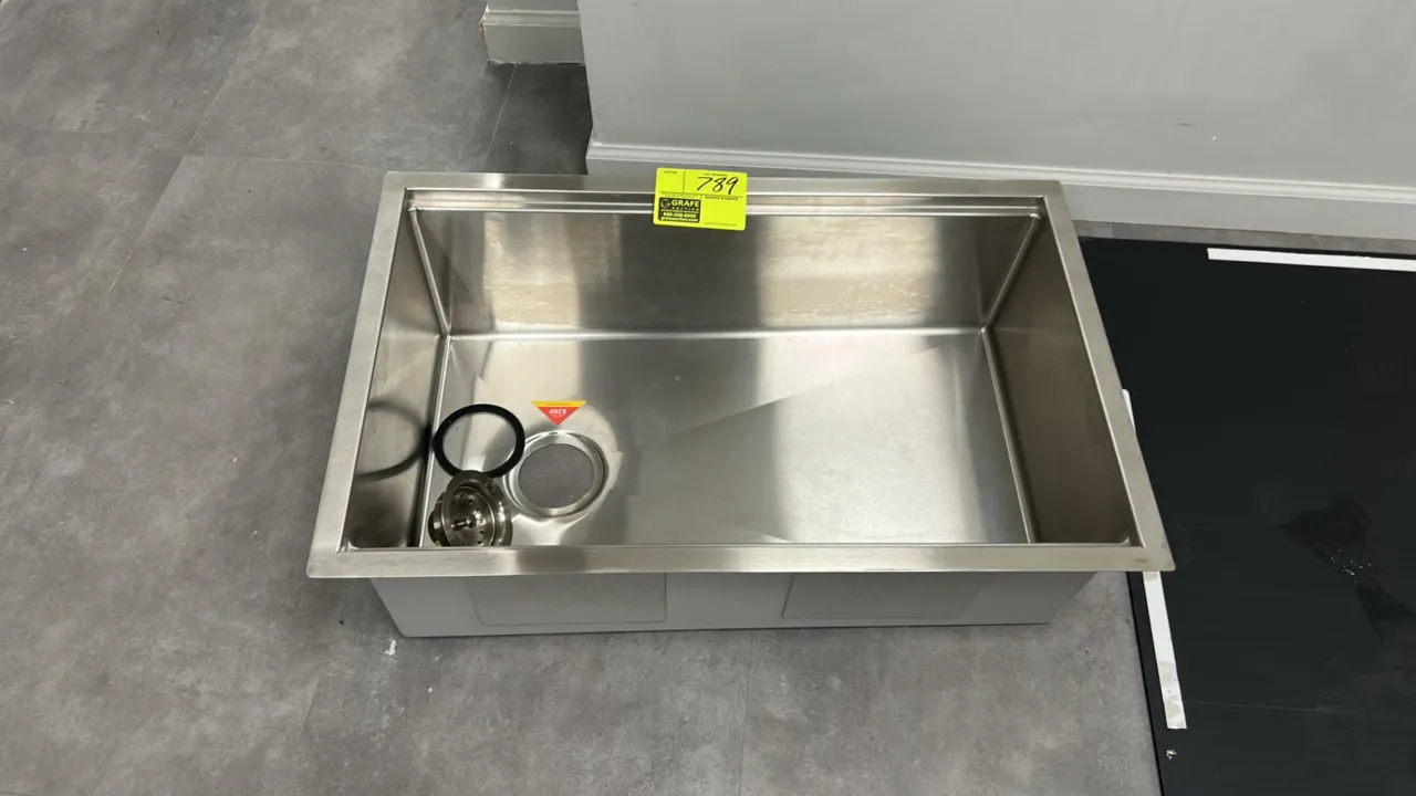Stainless steel sink insert. Features a single-bowl basin design, sound-deadening undercoating and pads, and includes drain strainer assembly. 30" x 1