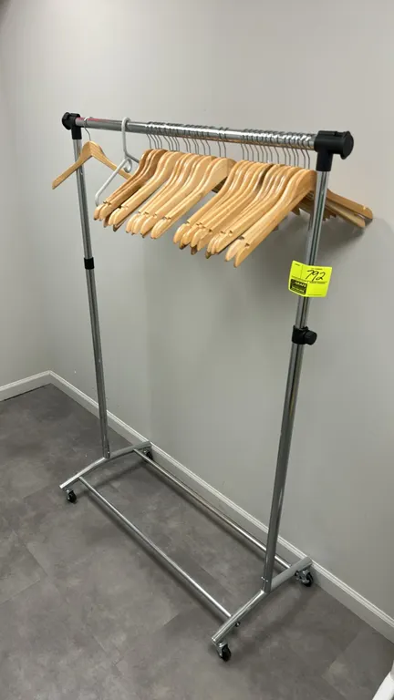Metal portable clothing rack. Features chrome finish, adjustable height uprights, and top hanging rail. 3'L. Mounted on swivel casters. Hangers not in