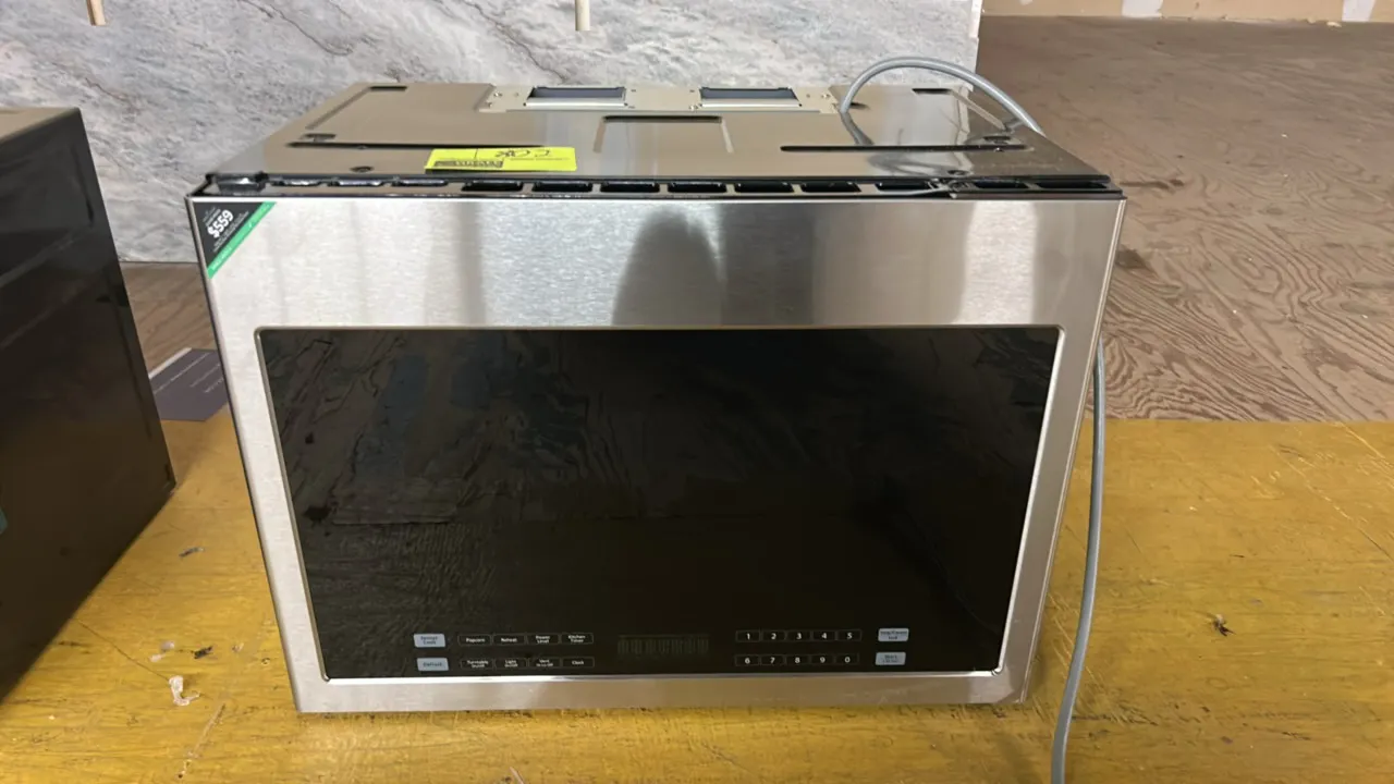 2021 Haier HMV1472B4HS over-the-range microwave oven. Features stainless steel finish, bottom digital touch controls, integrated ventilation, and glas