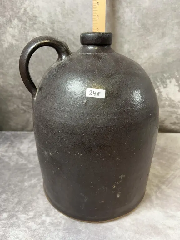 (2) Gallon Dark Brown Beehive Jug. Gray bottom. Ohio or PA maker. Very good condition no cracks or chips. Circa 1880-1910 "Orange Peel"