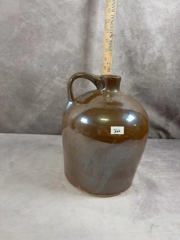 (1) Gallon Light Brown Albany Jug. Very good condition with one chip on the mouth. Circa 1870-1890