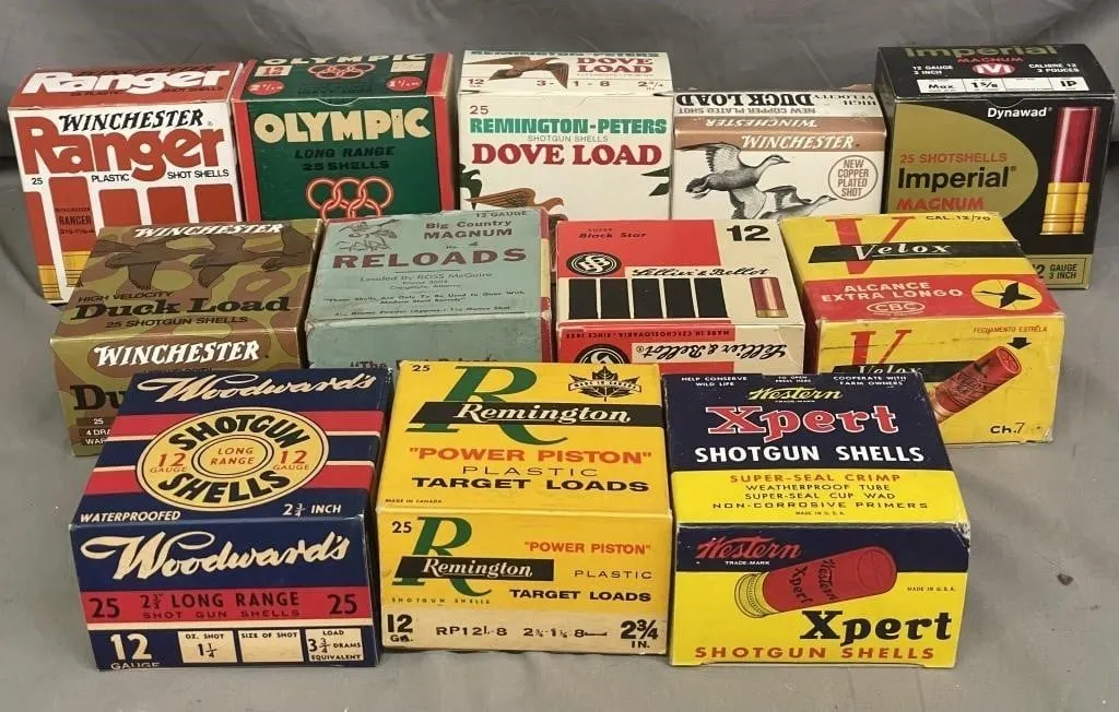 Twelve empty vintage shotgun shell boxes.