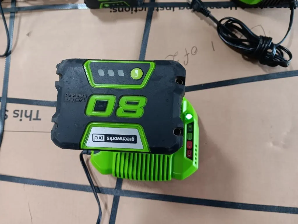 Greenworks 80V Battery With Charging Base. Turned