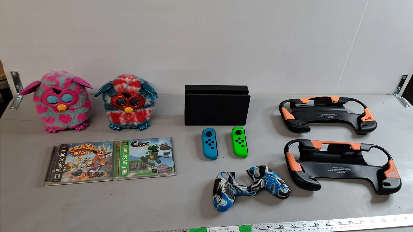 (2) Furbies- One Powers On, (2) Playstation Games, Nintendo Switch Console Docks, Misc.