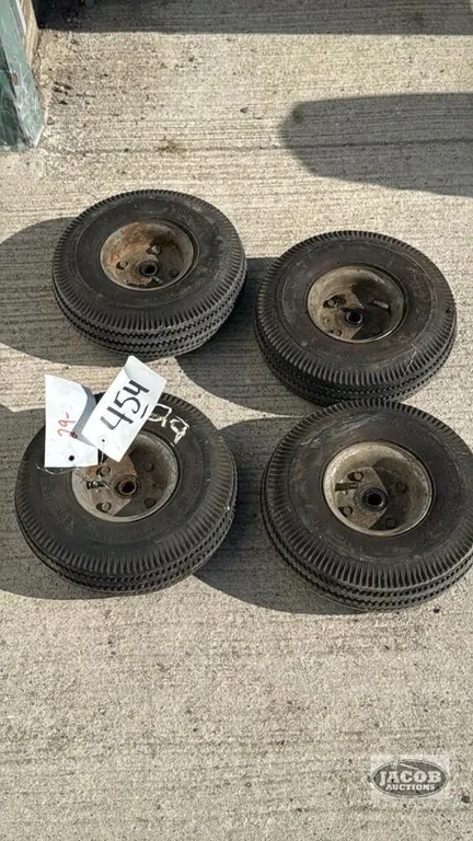 (4) SMALL PNUEMATIC TIRES ON RIMS