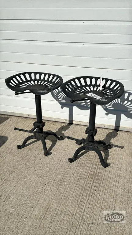 PAIR OF MATCHING CAST IRON TRACTOR SEAT STOOLS