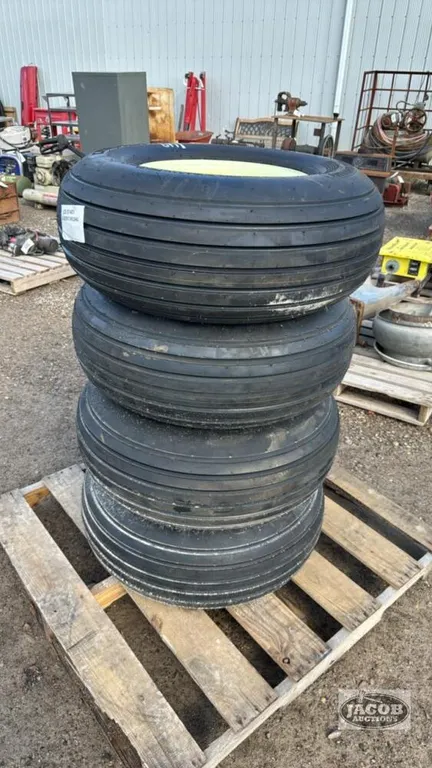 SET OF 4 UNUSED 11L15 TIRES AND RIMS