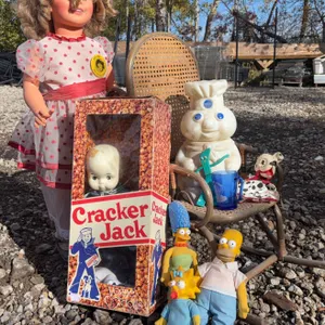 Dolls and Toys Including Pillsbury Doughboy, Simpsons, and Cracker Jack Doll