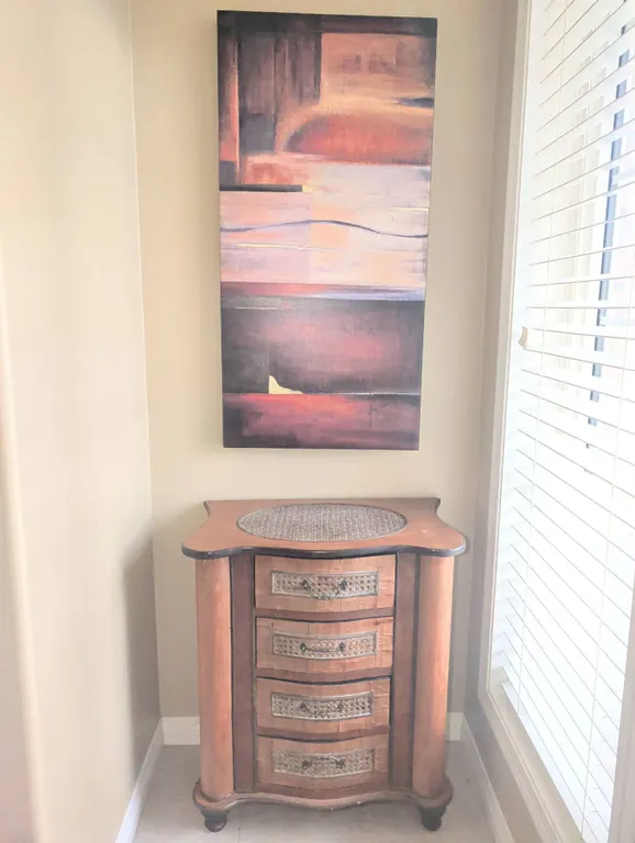 Small Wood Chest of Drawers with Carved Details and Abstract Wall Art