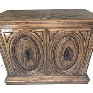 Carved Wood Cabinet with Ornate Brass Handles and Double Doors