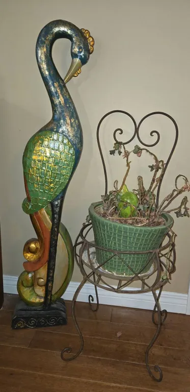 Painted Peacock Sculpture and Wrought Iron Plant Stand With Green Planter Pot