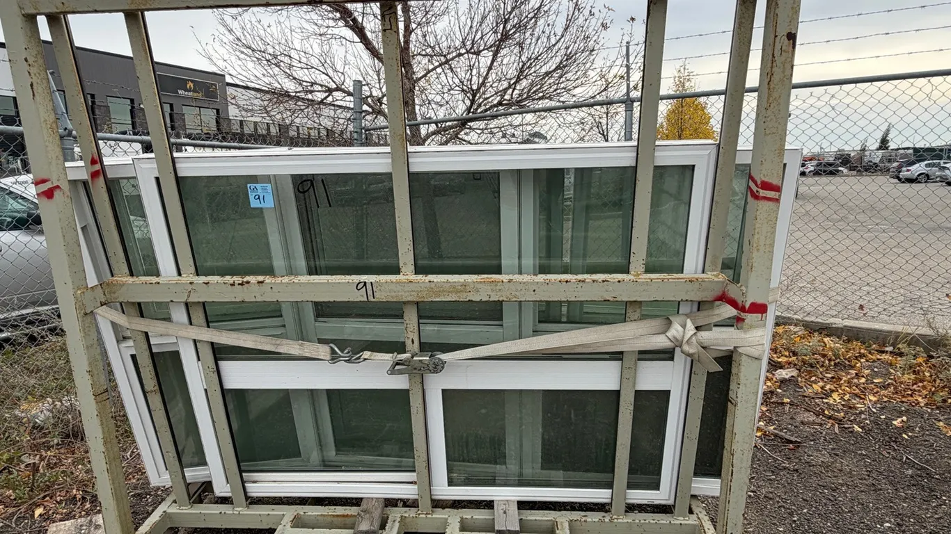 Metal transport rack & 10 white vinyl-framed sliding windows with glass panes and insect screens
