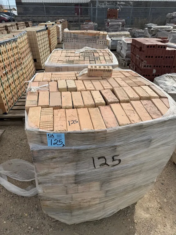 3 pallets tan/buff-coloured clay masonry bricks featuring 10-hole construction. Includes a mixture of smooth and textured finishes. Palletized and shr