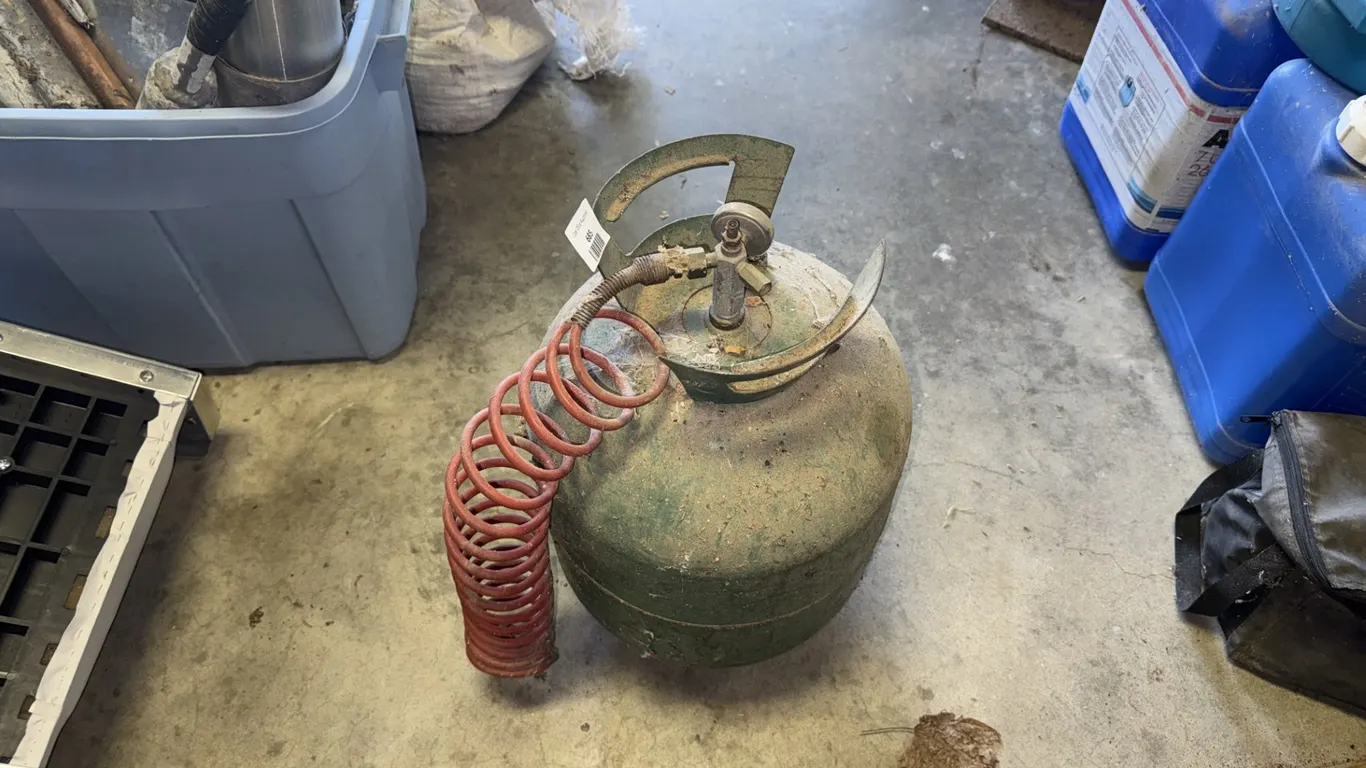Green Portable Air Tank with Red Coiled Hose
