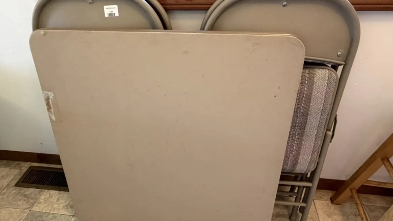 Beige Folding Card Table and Four Metal Folding Chairs