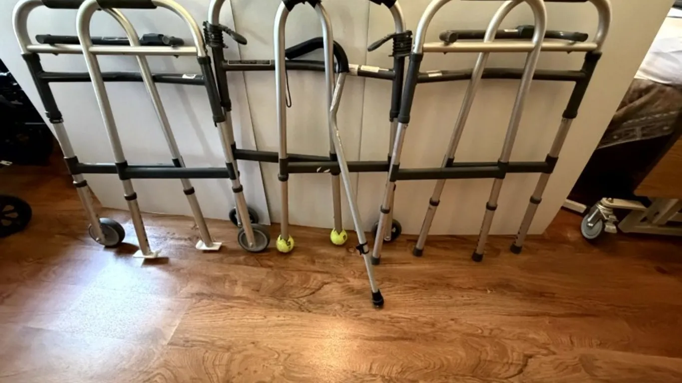 Three Invacare Folding Walkers and One Invacare Offset Cane