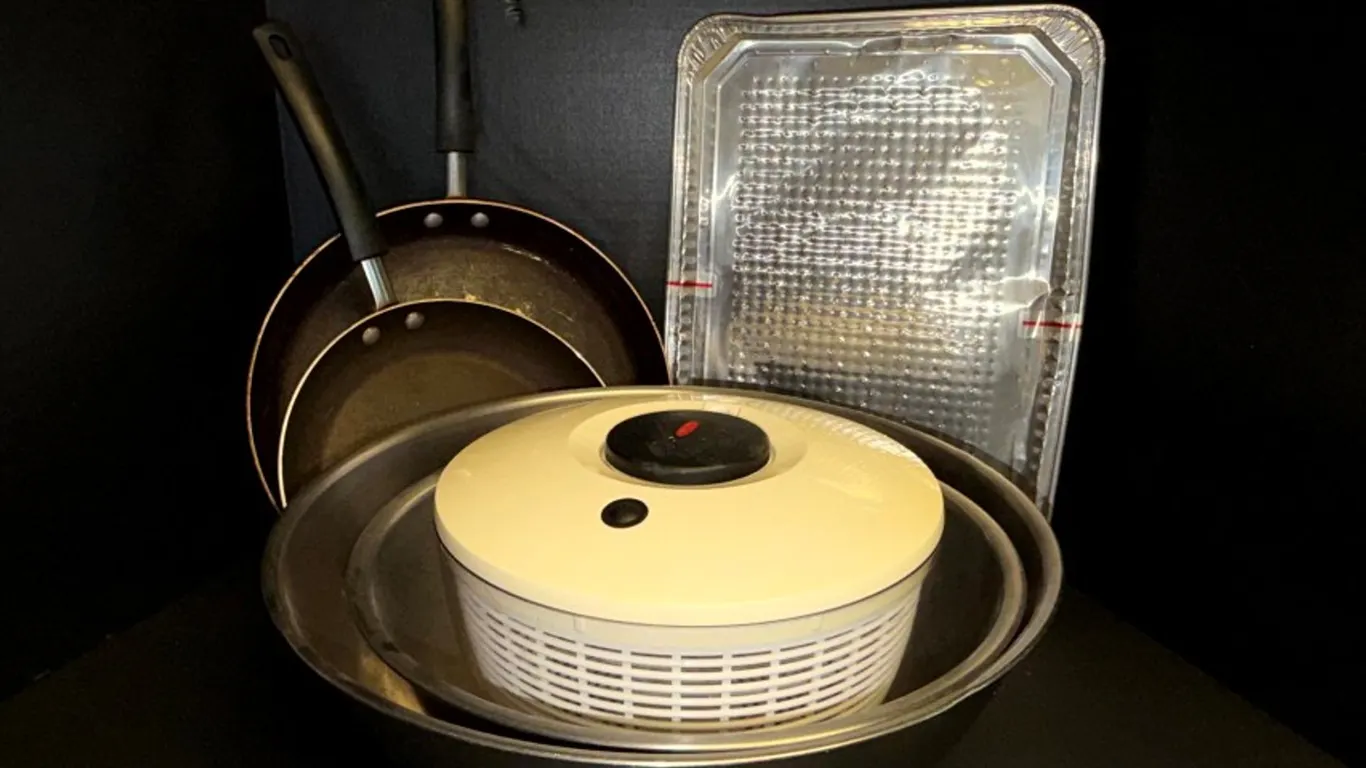 Assorted Kitchenware: Frying Pans, Salad Spinner, Mixing Bowls, and Disposable Aluminum Pans