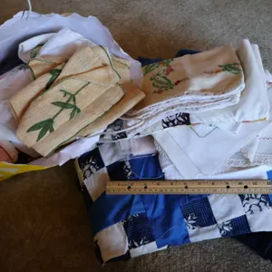 Assorted Embroidered Linens, Patchwork Quilt Pieces, and Fabric Scraps