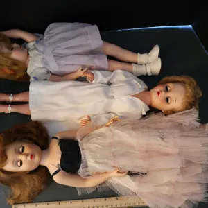 Three Fashion Dolls with Sleep Eyes, Tiered Pink Tulle Gown, White Coat Dress, and Lavender Pinafore