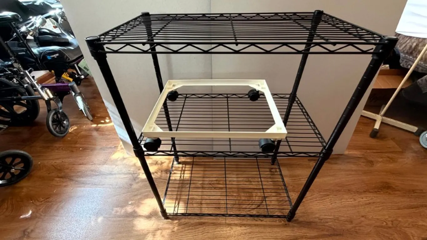 Black Three-Tier Wire Shelving Rack and White Plastic Mobile Stand on Casters