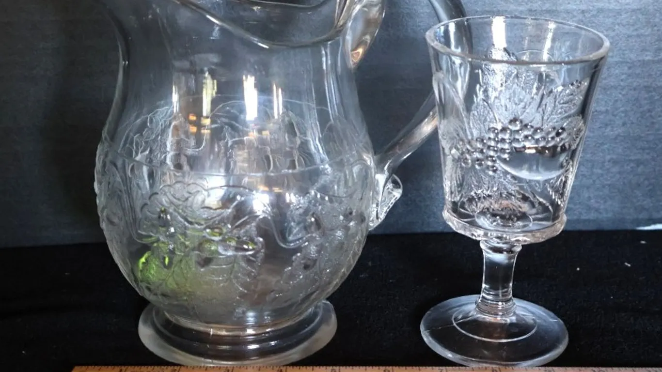 Clear Pressed Glass Pitcher and Stemmed Goblet, Embossed Grape Motif