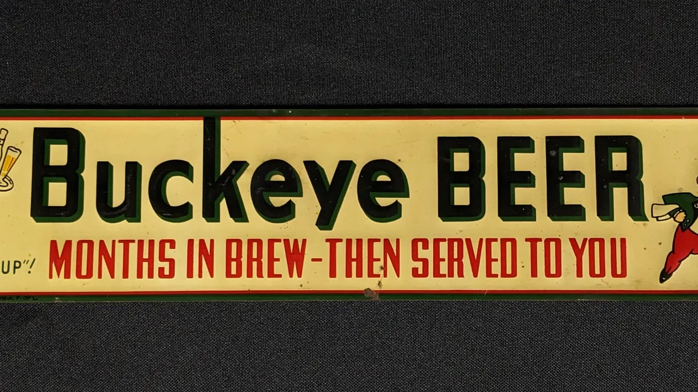 EMBOSSED TIN SIGN BUCKEYE BEER MONTHS IN BREW - THEN SERVED TO YOU