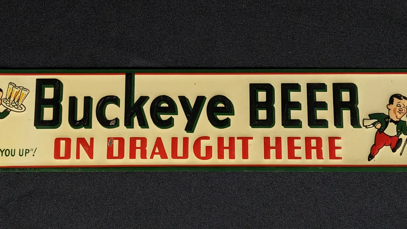 EMBOSSED TIN SIGN BUCKEYE BEER ON DRAUGHT HERE