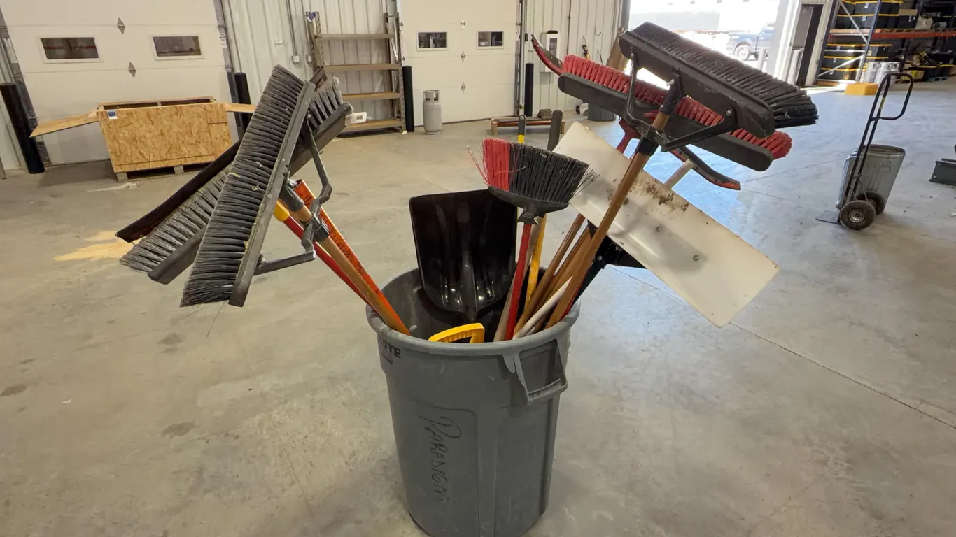 Assortment of Brooms and Shovels