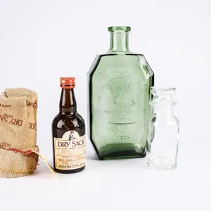 A Grouping of Three Vintage Cool Bottles.  An Anchor Hocking Green Bottle, A Mini Apothecary Jar, &