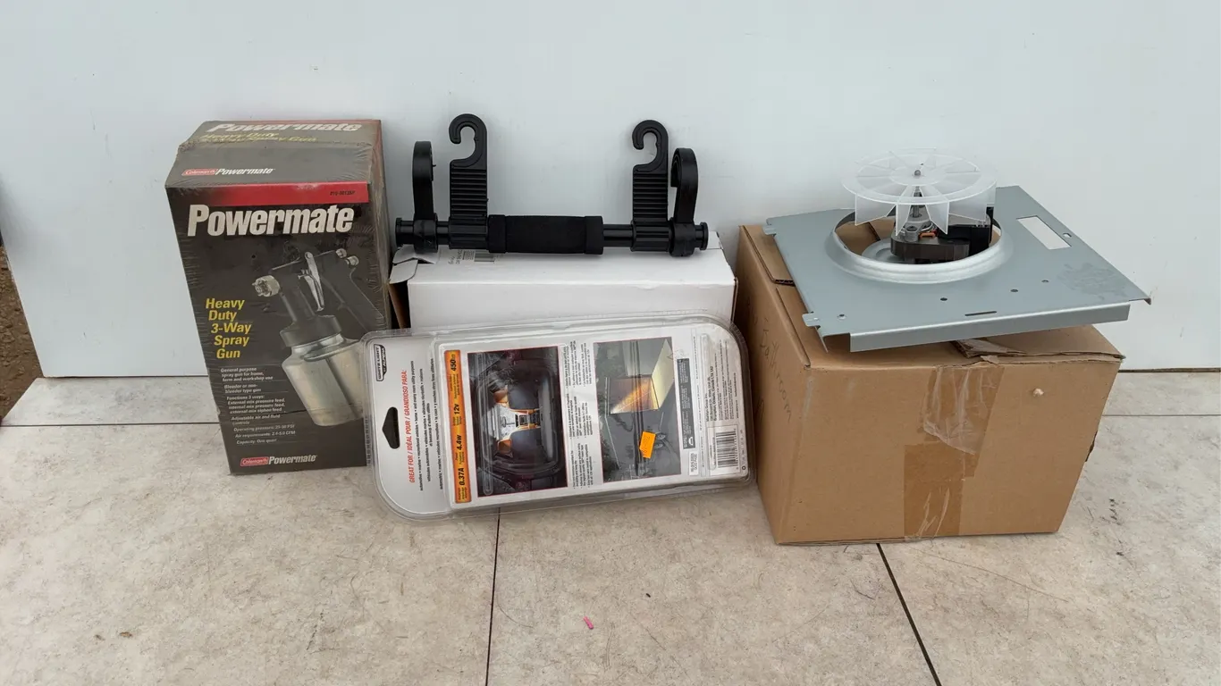 Unused powermate three-way paint spray gun, pair of head rest hangers, a new bath fan, cargo light