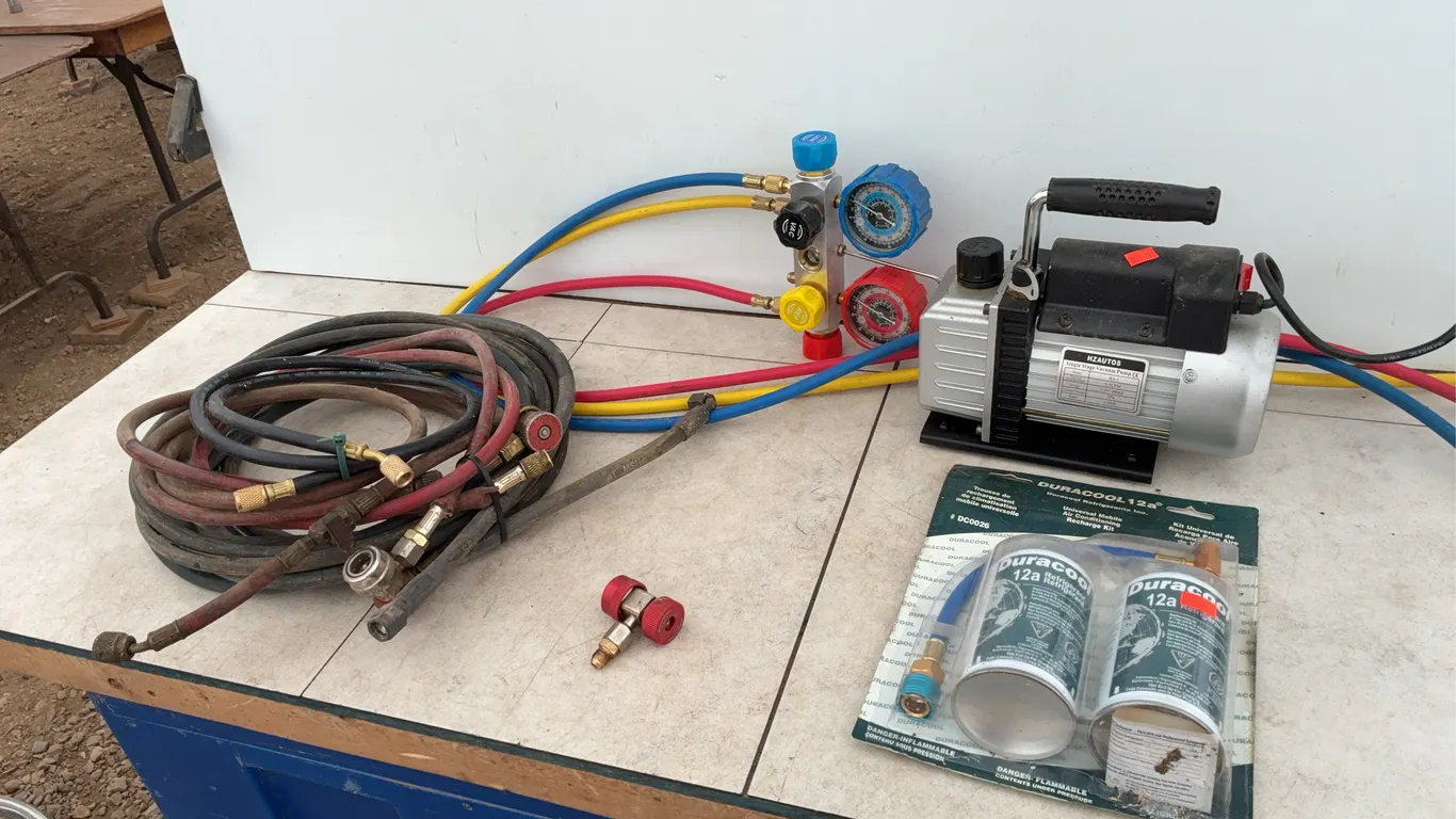 Refrigeration pump, gauges, hoses, two cans of Dura cool 12 A