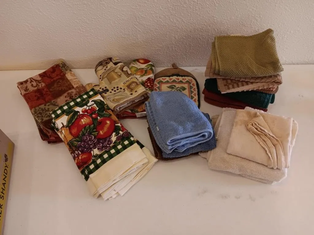 Variety of dish towels, rags, and oven mits.