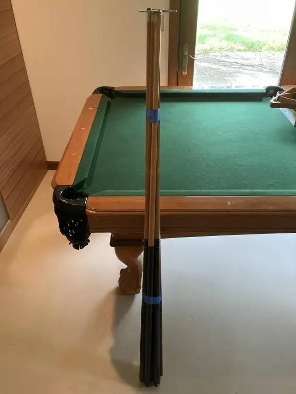 Six Pool cues and crutch