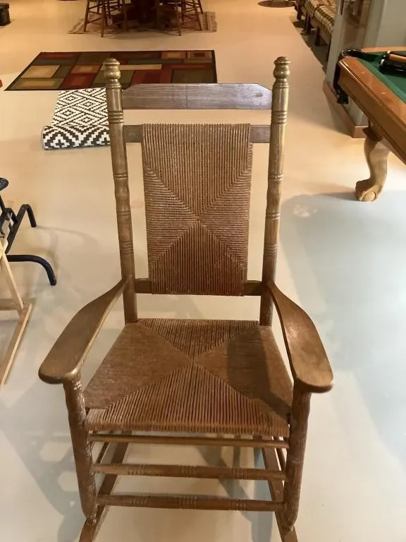 Cracker Barrel Wooden rocker with woven cord.