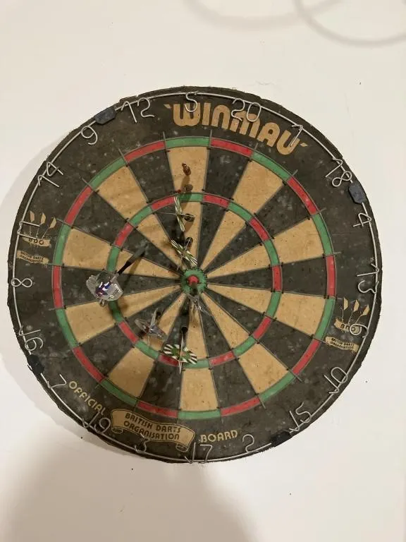 Winmau dart board with darts