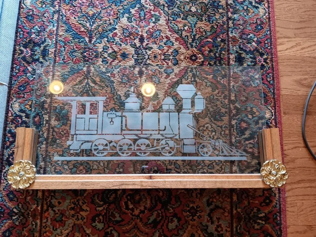 Vintage etched glass panel featuring train